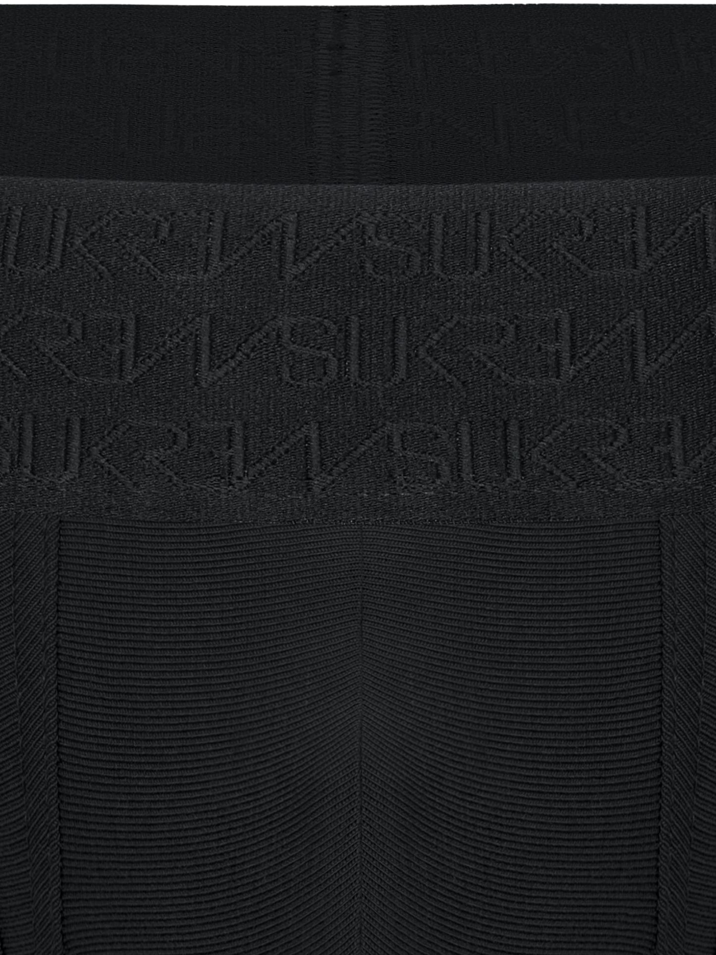 Close-up of a black ribbed knit garment with a wide waistband featuring an embossed repeating SUKREW logo pattern.