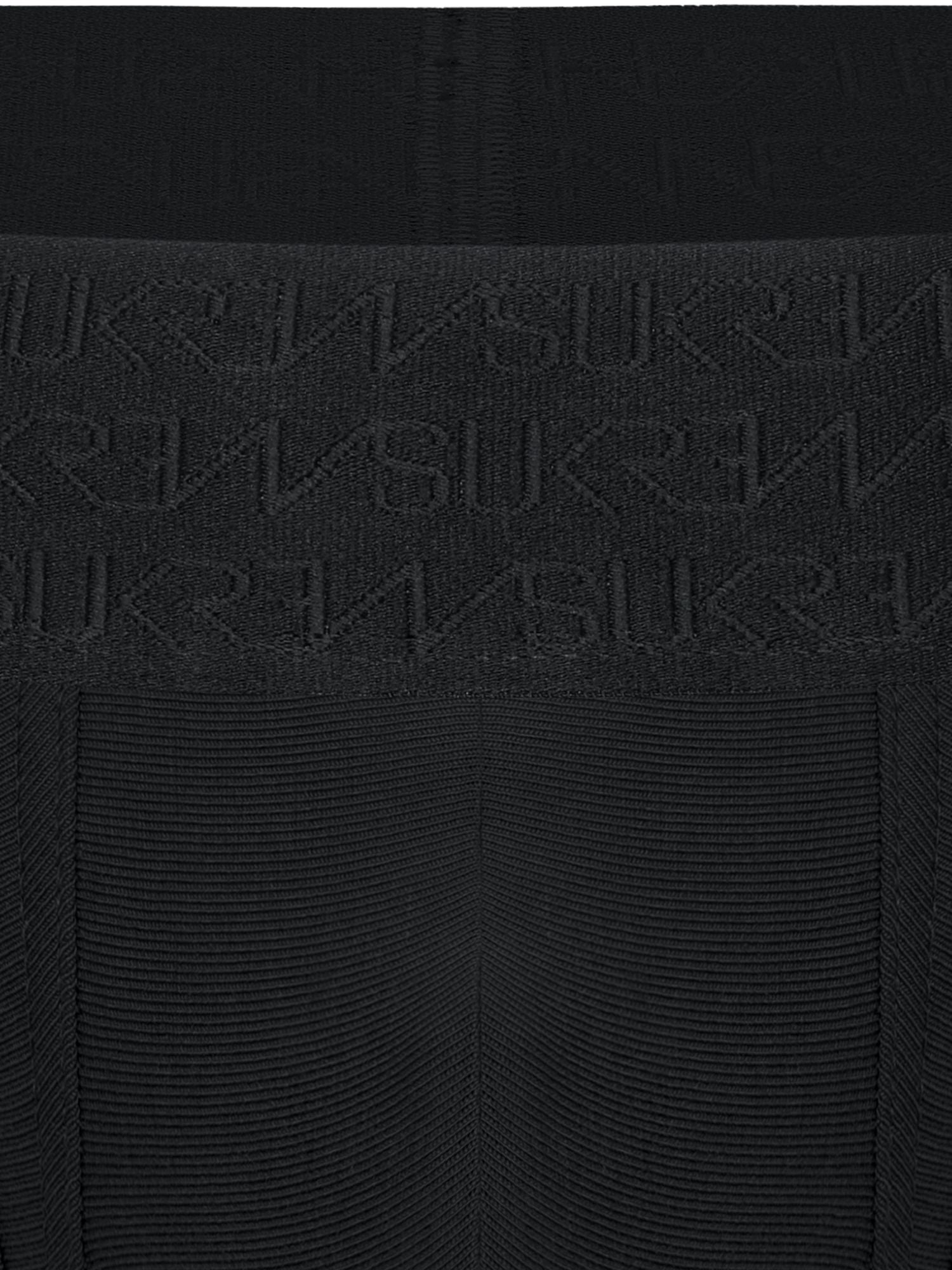 Close-up of a black ribbed knit garment with a wide waistband featuring an embossed repeating SUKREW logo pattern.