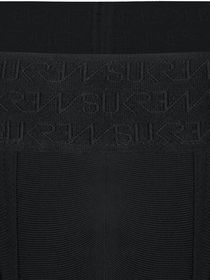 Close-up of a black ribbed knit garment with a wide waistband featuring an embossed repeating SUKREW logo pattern.