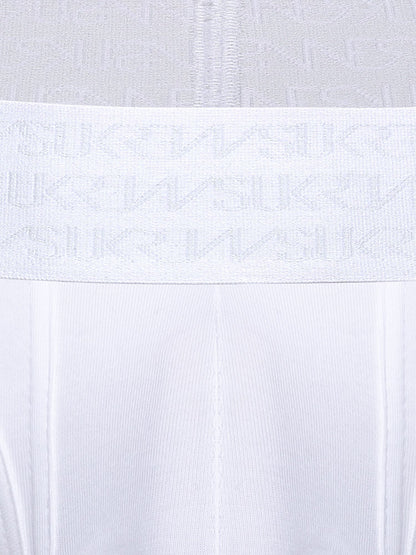Close-up of a white underwear or garment waistband with a repeating tonal SUKREW logo pattern, shown against matching white fabric.