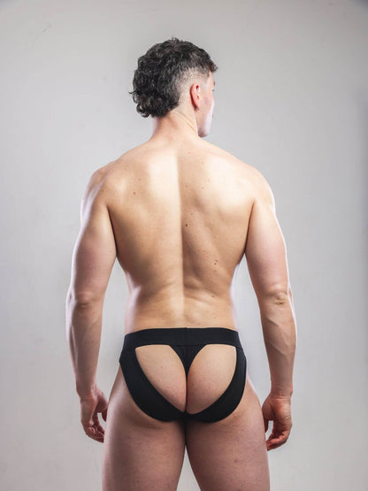 Man wearing a black men's underwear on a plain background