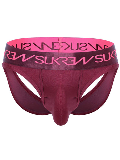 A men's jockstrap in a deep burgundy color, featuring a wide waistband with a bright pink inner lining and pink brand lettering that reads 'SUKREW' in reverse. The brand name 'SUKREW' is also printed in black on the outer waistband.