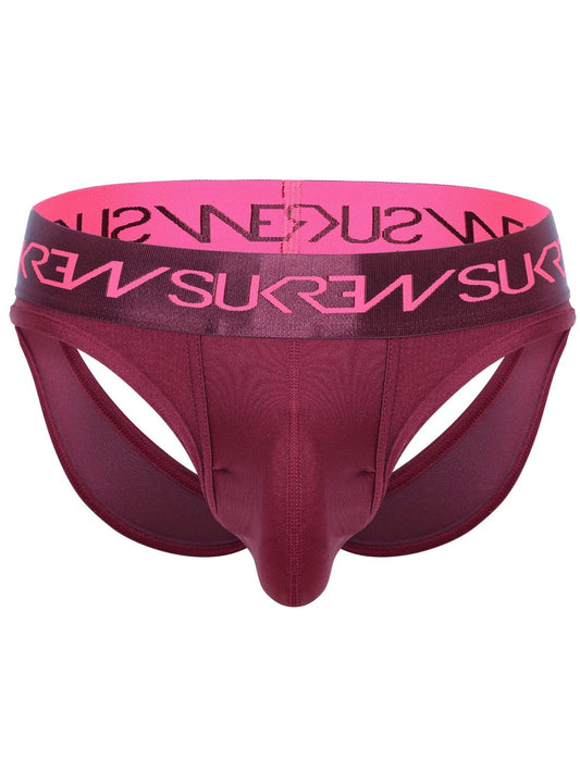 A men's jockstrap in a deep burgundy color, featuring a wide waistband with a bright pink inner lining and pink brand lettering that reads 'SUKREW' in reverse. The brand name 'SUKREW' is also printed in black on the outer waistband.