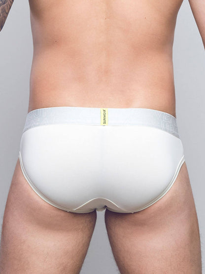Rear view of a man wearing white briefs with a light gray elastic waistband and a small yellow brand tab.