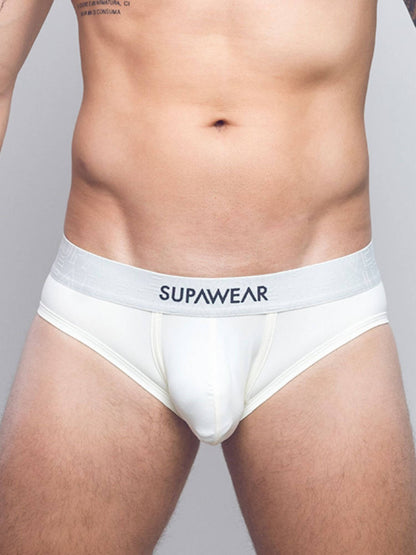 A close-up of a male model's lower torso wearing white briefs with a wide waistband and the brand name 'SUPAWEAR' printed in black on the front.