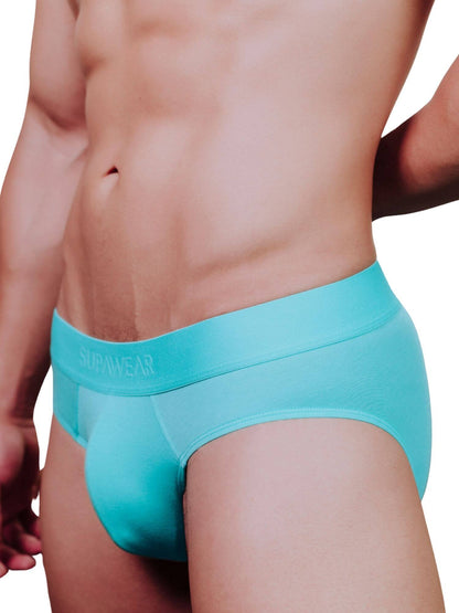 A close-up of a male model wearing bright turquoise blue briefs with the brand name 'SUPAWEAR' printed on the front waistband, set against a plain white background.