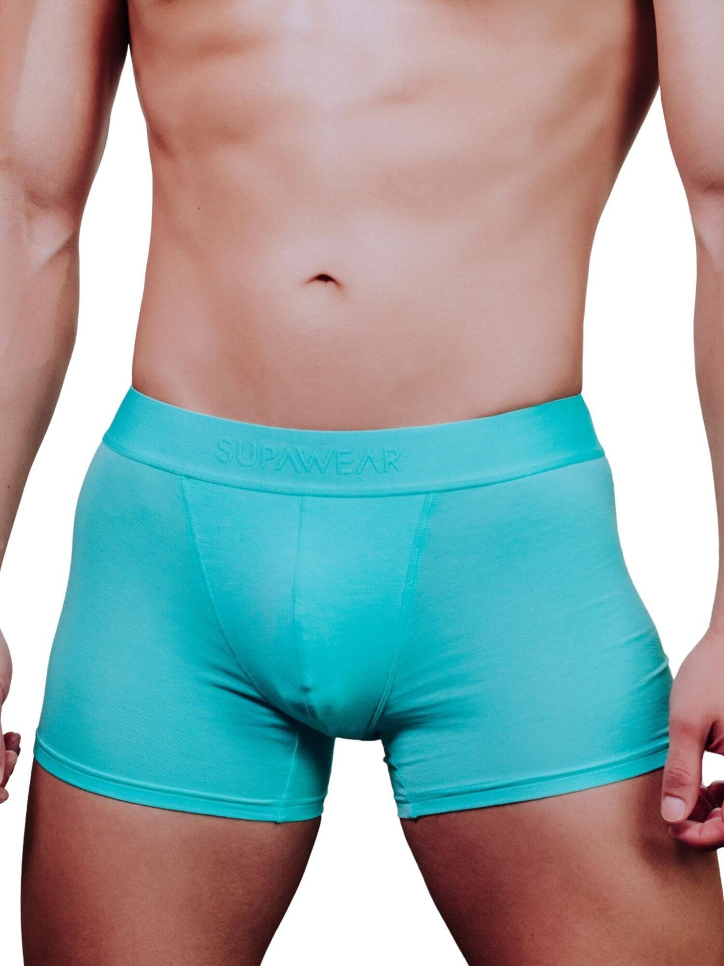 A close-up of a male model's lower torso wearing turquoise boxer briefs with the brand name 'SUPAWEAR' printed on the waistband, set against a plain white background.