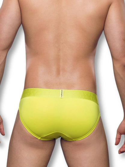 Person wearing a bright green men's underwear on a white background