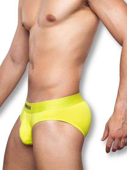 Person wearing a bright yellow men's underwear on a white background