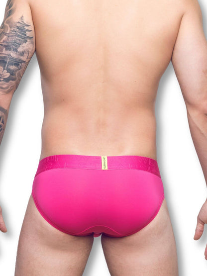 Person wearing bright pink underwear on a white background