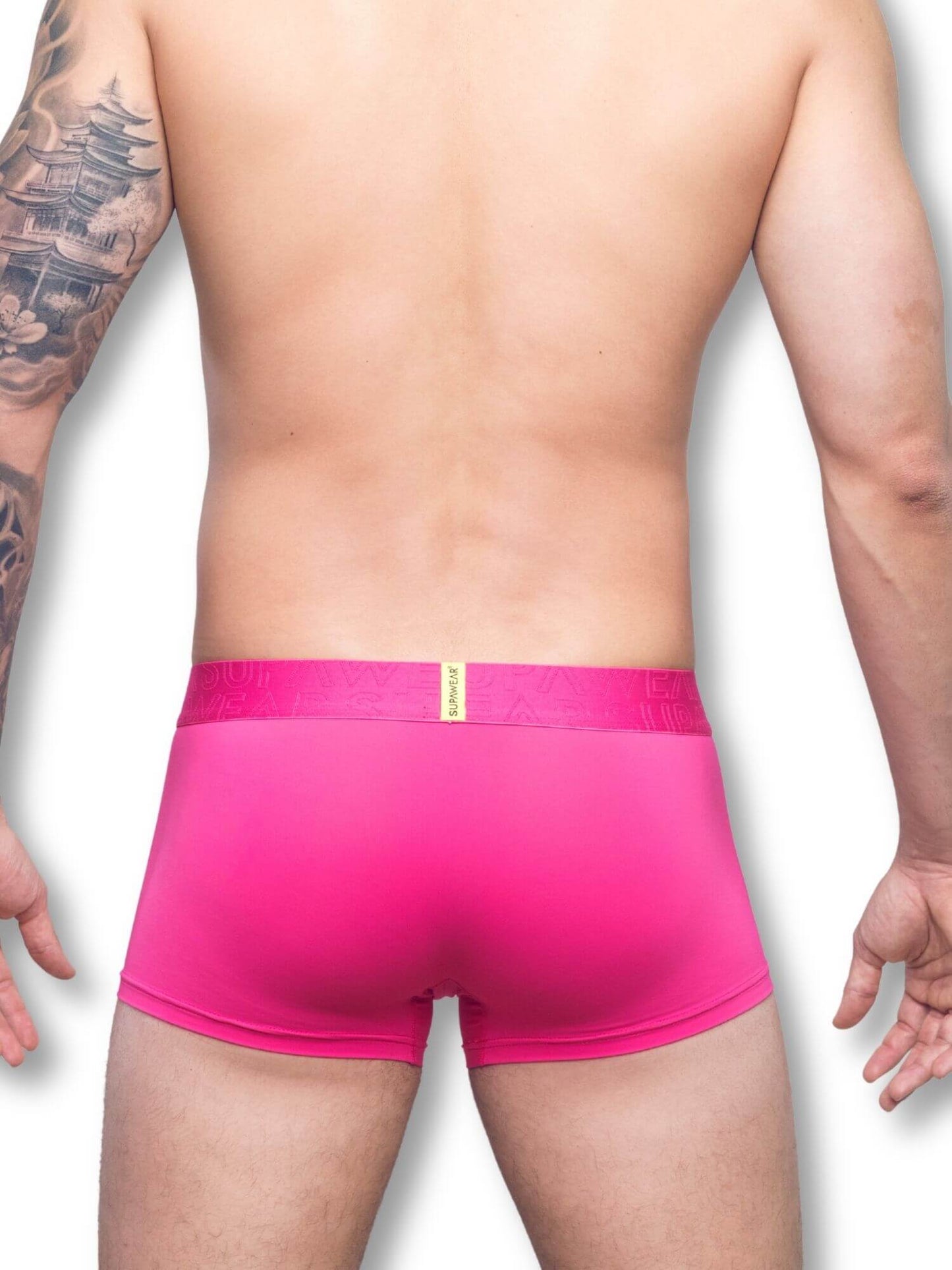 Person wearing bright pink underwear on a white background