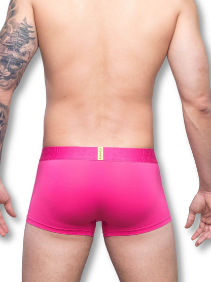 Person wearing bright pink underwear on a white background