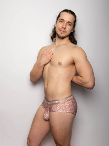 Man wearing a patterned underwear set against a plain background