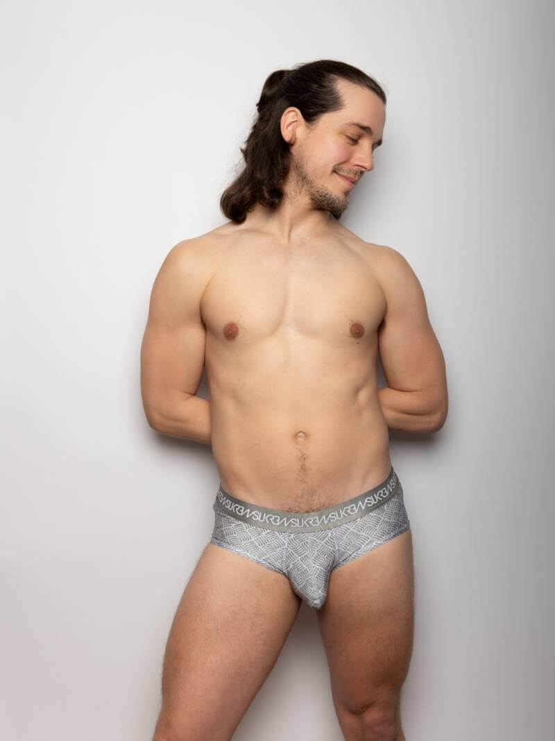 Man wearing gray underwear against a plain background