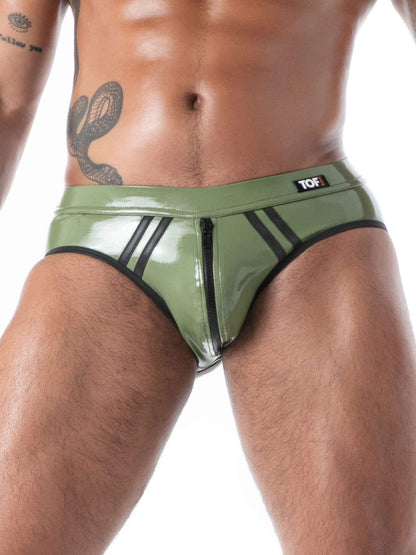 Person wearing green latex underwear with a brand logo on a white background