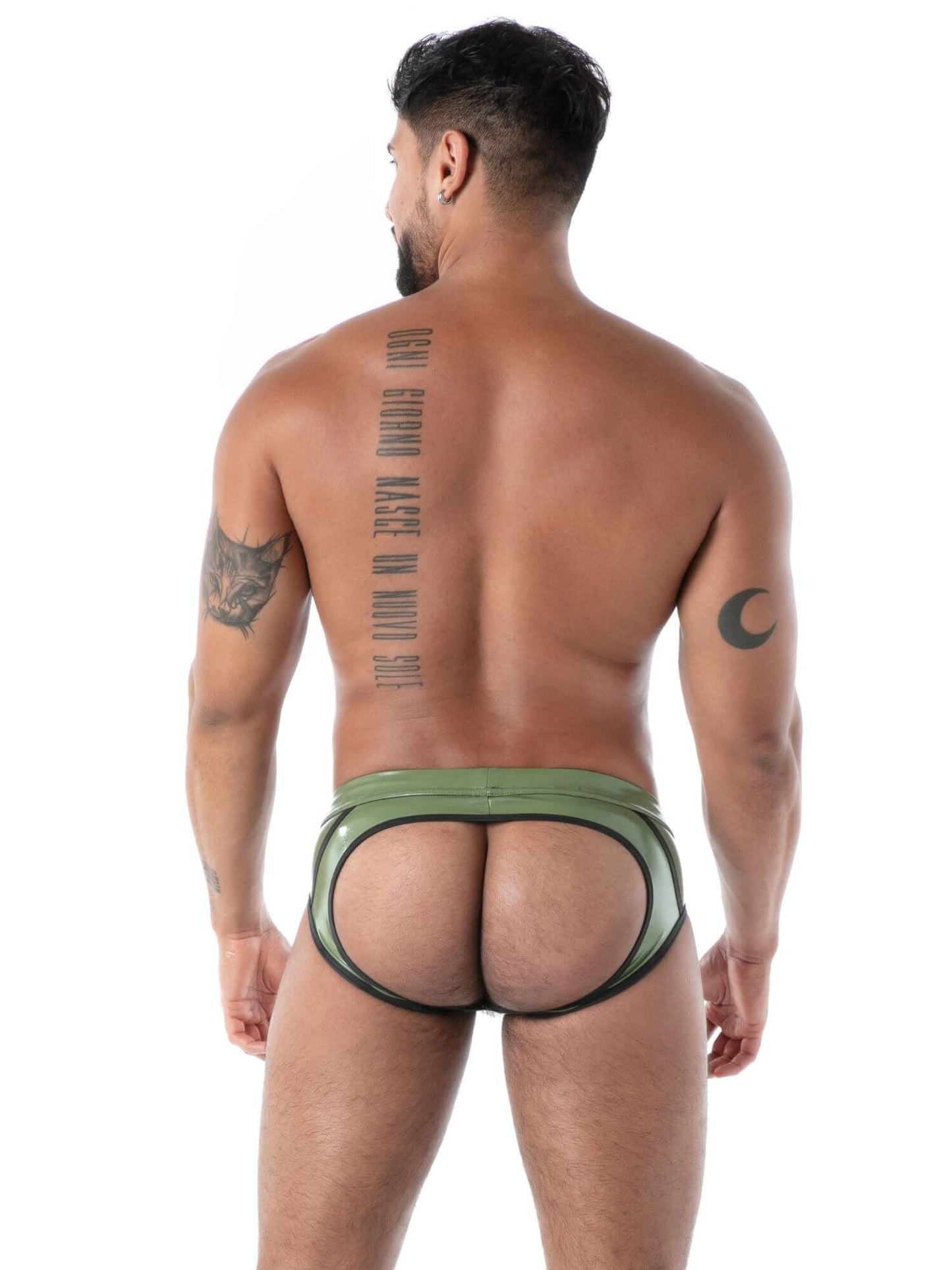 Man wearing a green latex backless brief with a white background