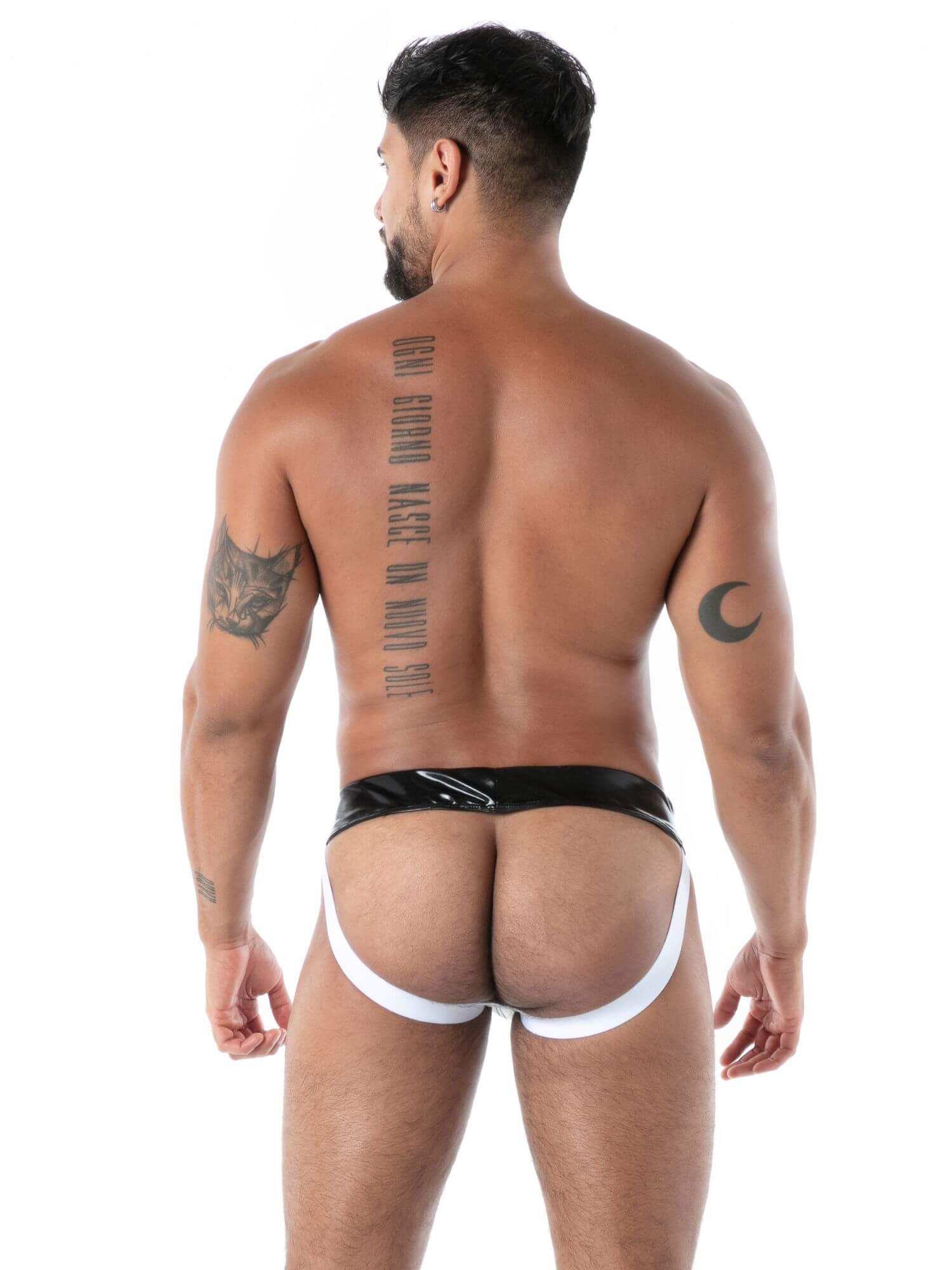 Man wearing a black and white latex jockstrap on a white background