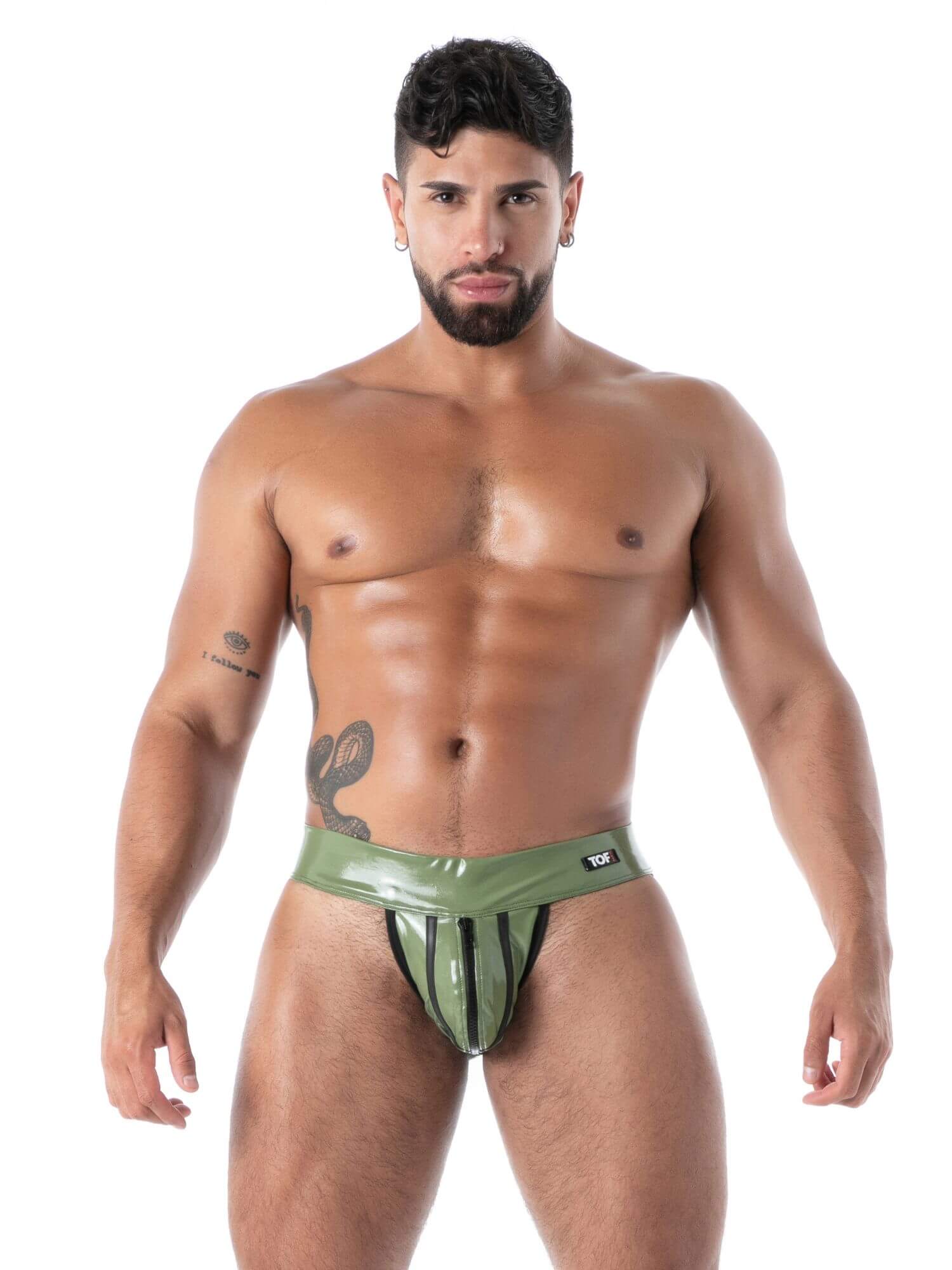 Man wearing a green and black striped jockstrap on a white background