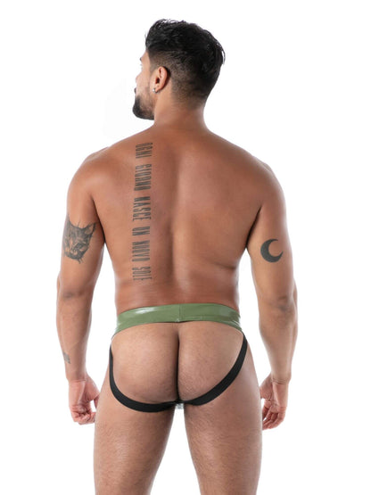 Man wearing a green latex jockstrap on a white background