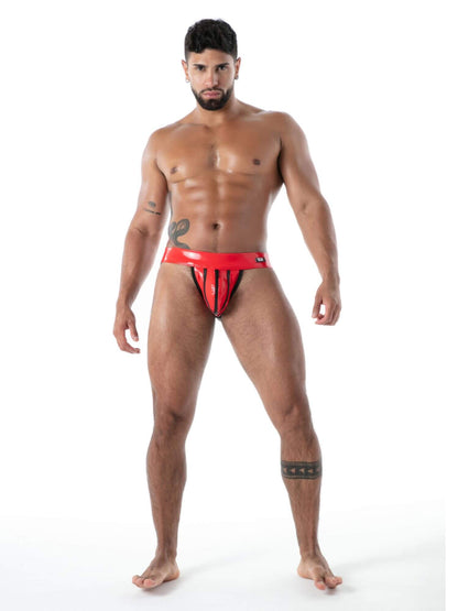 Man wearing a red latex jockstrap on a white background