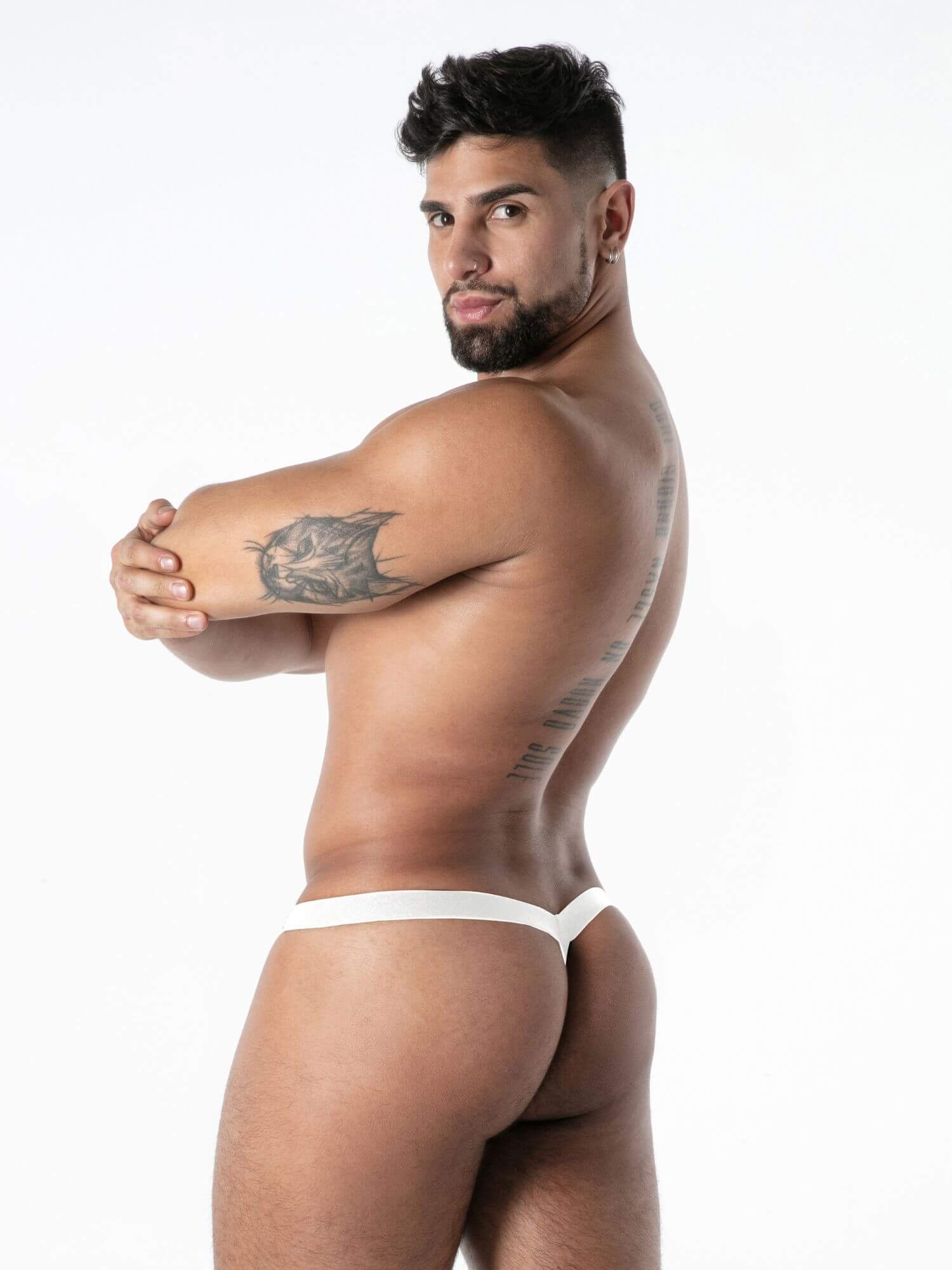 Man wearing a white thong against a white background