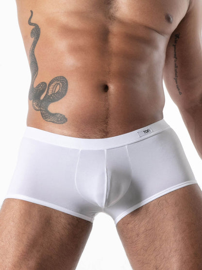 Man wearing white boxer briefs with a snake tattoo on his side.