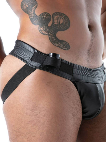 Man wearing a black leather jockstrap on a white background
