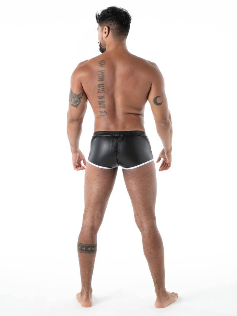 Man wearing black leather shorts on a white background