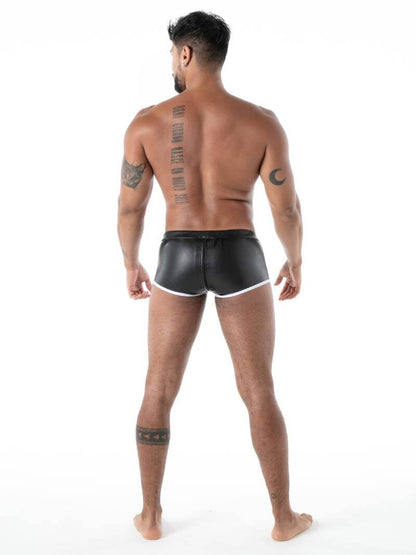 Man wearing black leather shorts on a white background