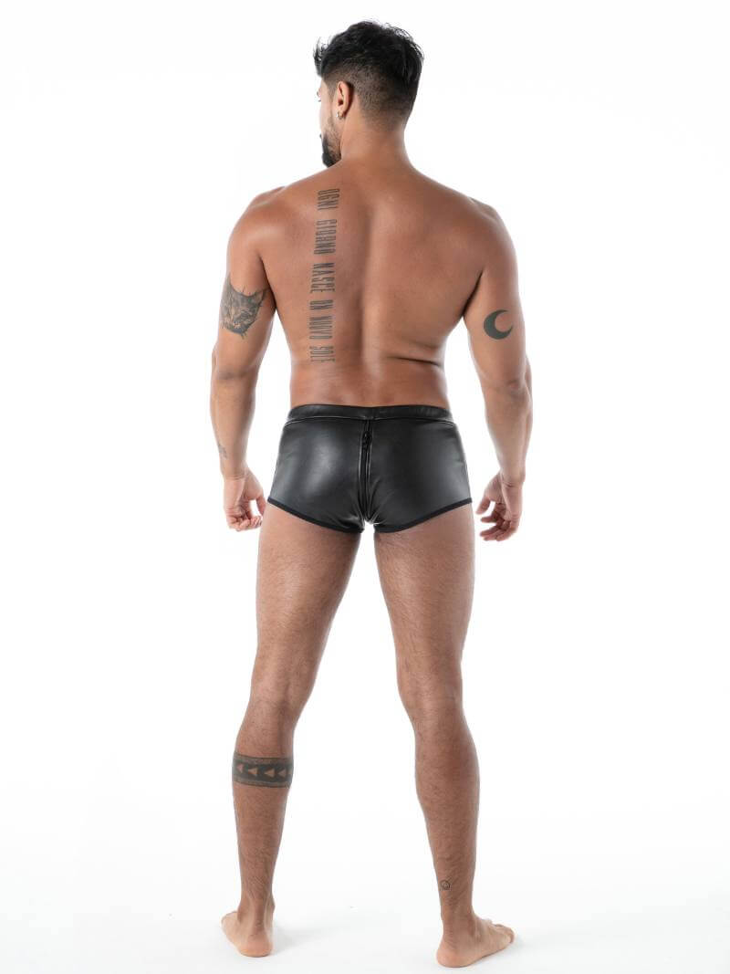 Man wearing black leather shorts on a white background