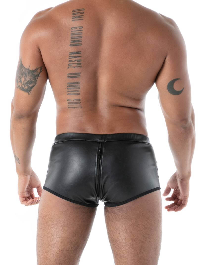 Man wearing black leather shorts with tattoos on his back and arms.