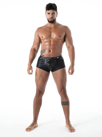 Man wearing black leather shorts on a white background
