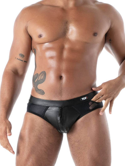 Man wearing a black swim brief with visible branding on a white background