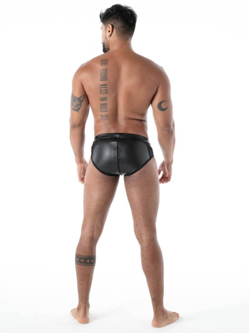 Man wearing black leather underwear on a white background