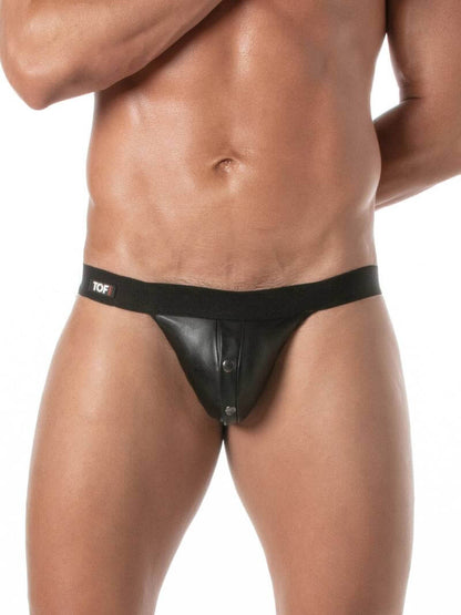 Man wearing a black leather jockstrap on a white background