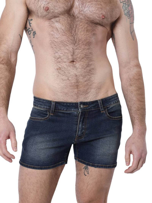 A pair of denim booty shorts with a low-rise waist and a 4-inch inseam, featuring a zipper fly, button fastening, belt loops, and four pockets. The shorts are blue with contrast stitching, and there is a leather branded patch on the back.