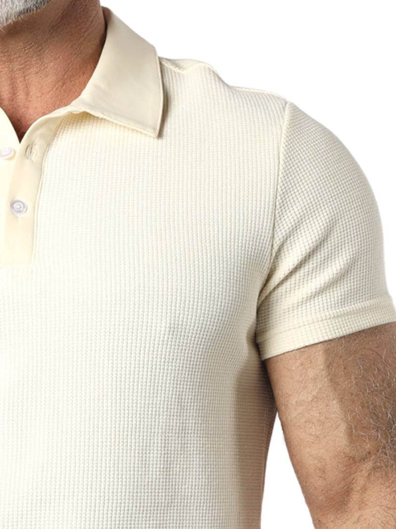 Close-up of a beige textured polo shirt on a person
