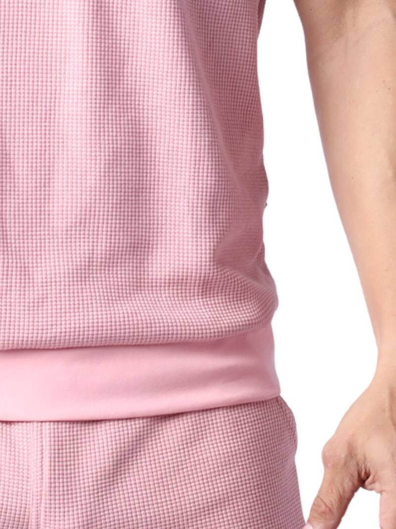 Close-up of a person wearing a pink checkered outfit on a white background