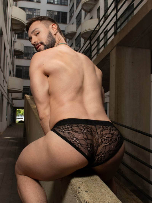 Man wearing black lace underwear in an urban setting