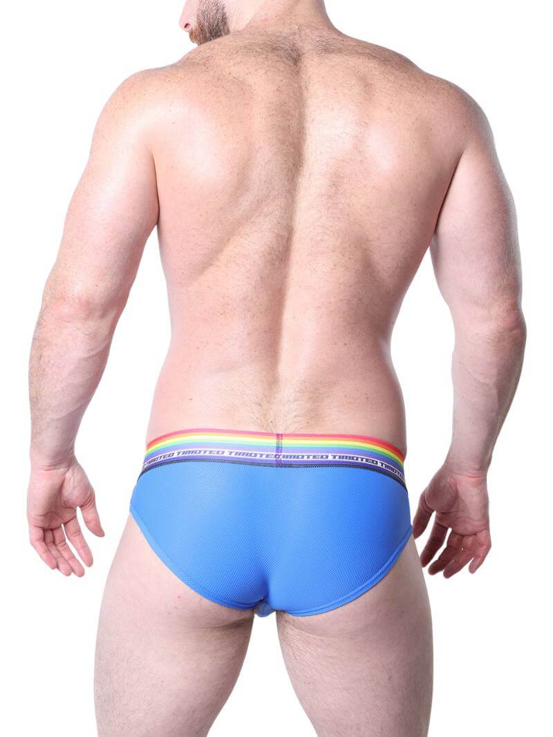 Man wearing pink underwear with rainbow waistband on a white background