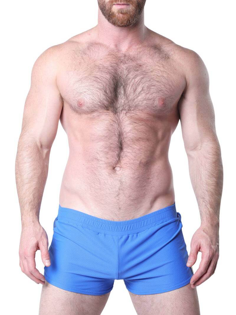 Man wearing blue underwear with mesh panels on a white background