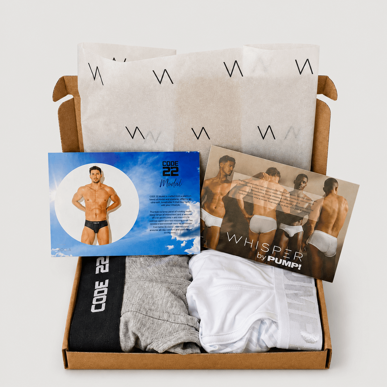 An example cardboard subscription box with two pairs of underwear for the VA CLUB men's underwear subscription service. The box contains CODE 22 Monochrome and PUMP! Whisper underwear products