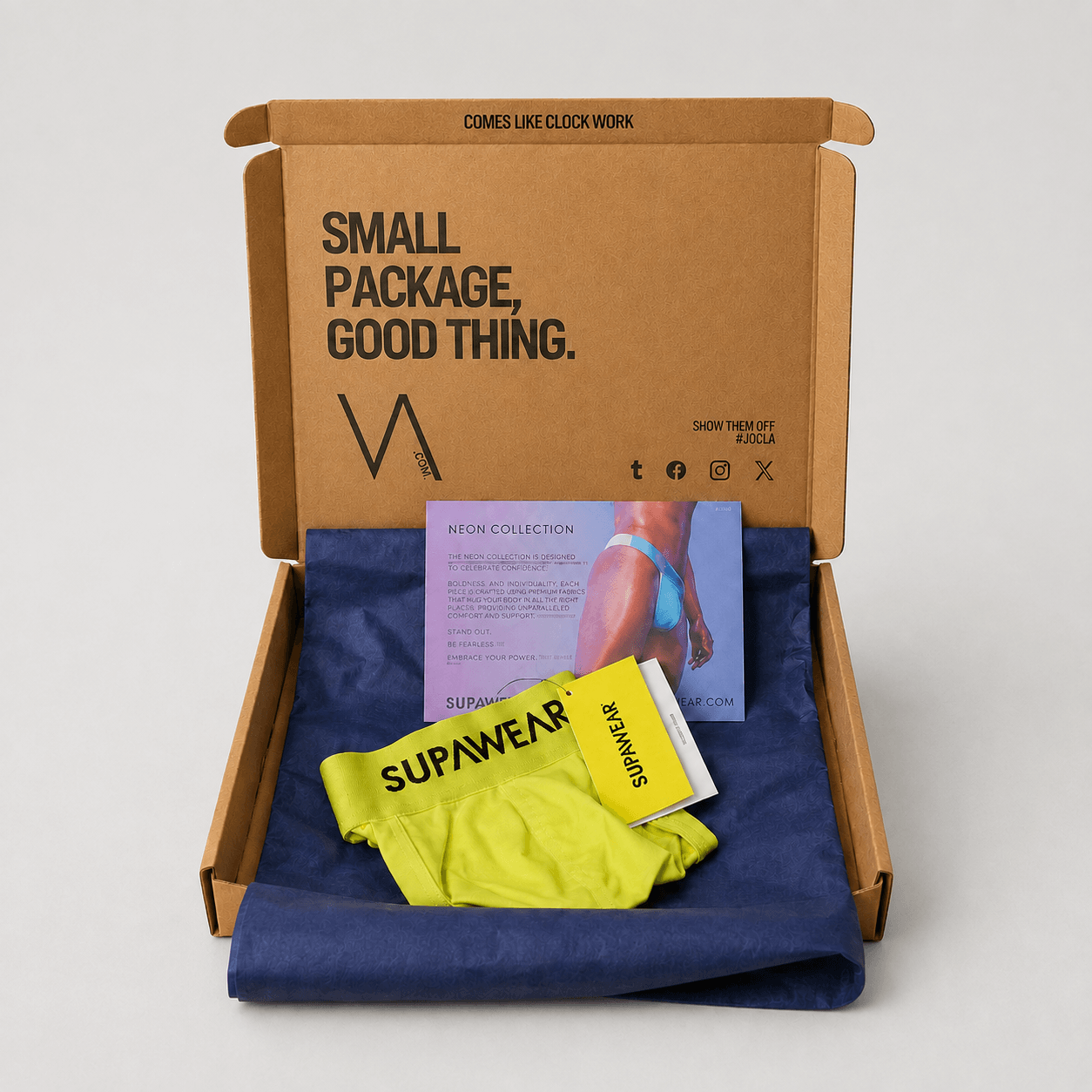 An open brown cardboard subscription box on a light gray background, containing a folded neon yellow/lime athletic top with black SUPAWEAR branding and a blue fabric lining. A printed insert card is visible inside the box.