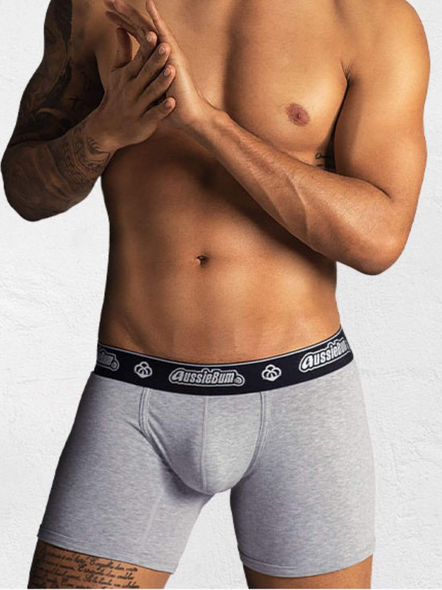 Person wearing gray underwear with a visible brand logo on a white background