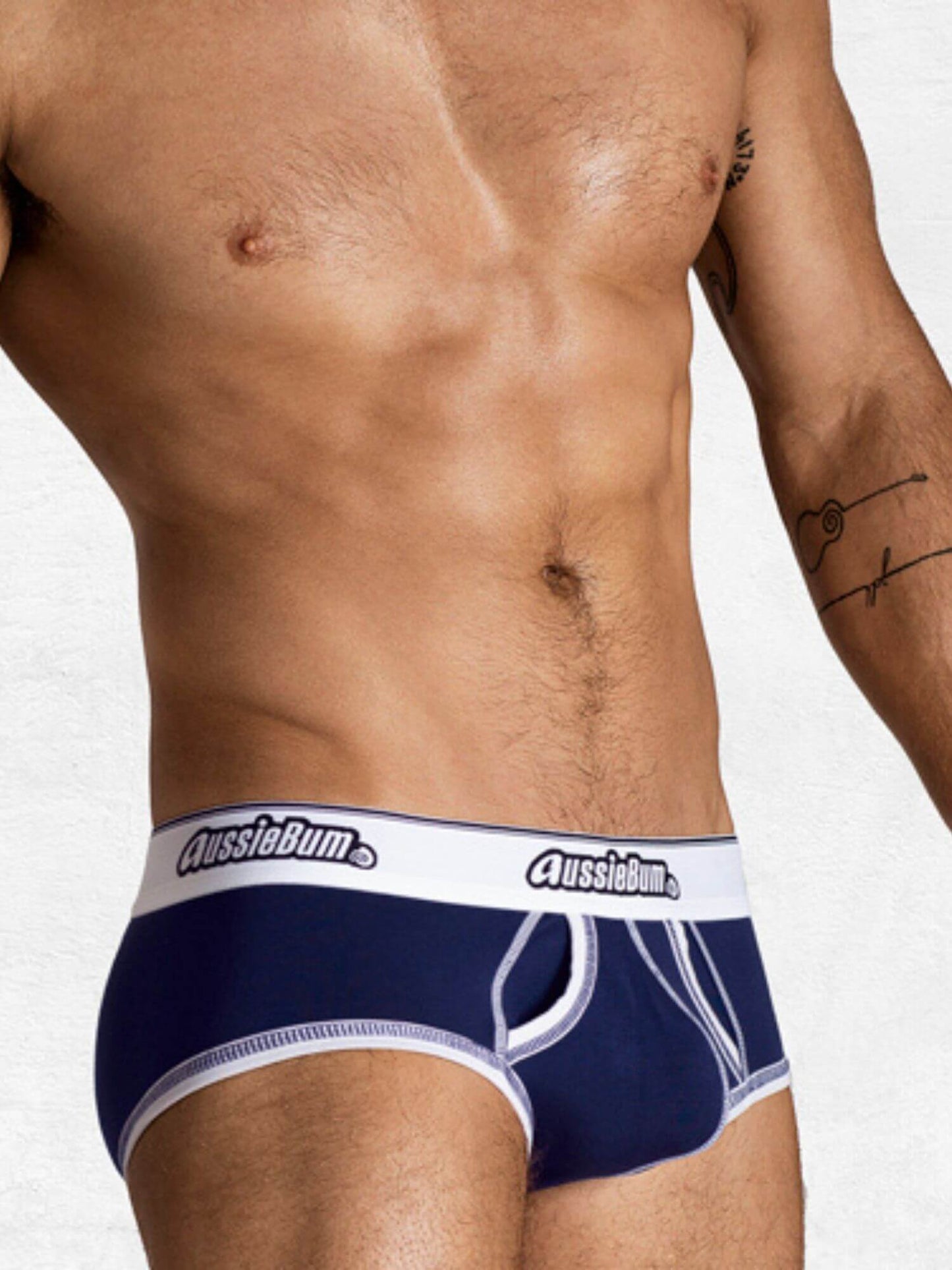Naked person wearing navy blue underwear with 'AussieBum' branding on a white background
