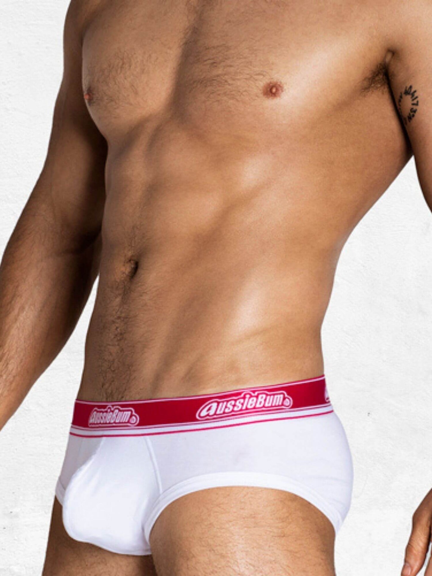White underwear with red waistband featuring 'AussieBum' brand on a plain background