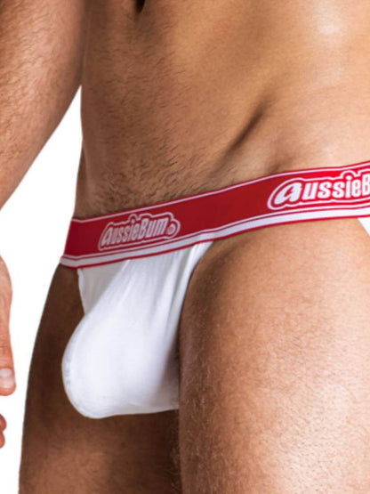 White underwear with red waistband featuring 'AussieBum' brand on a person.