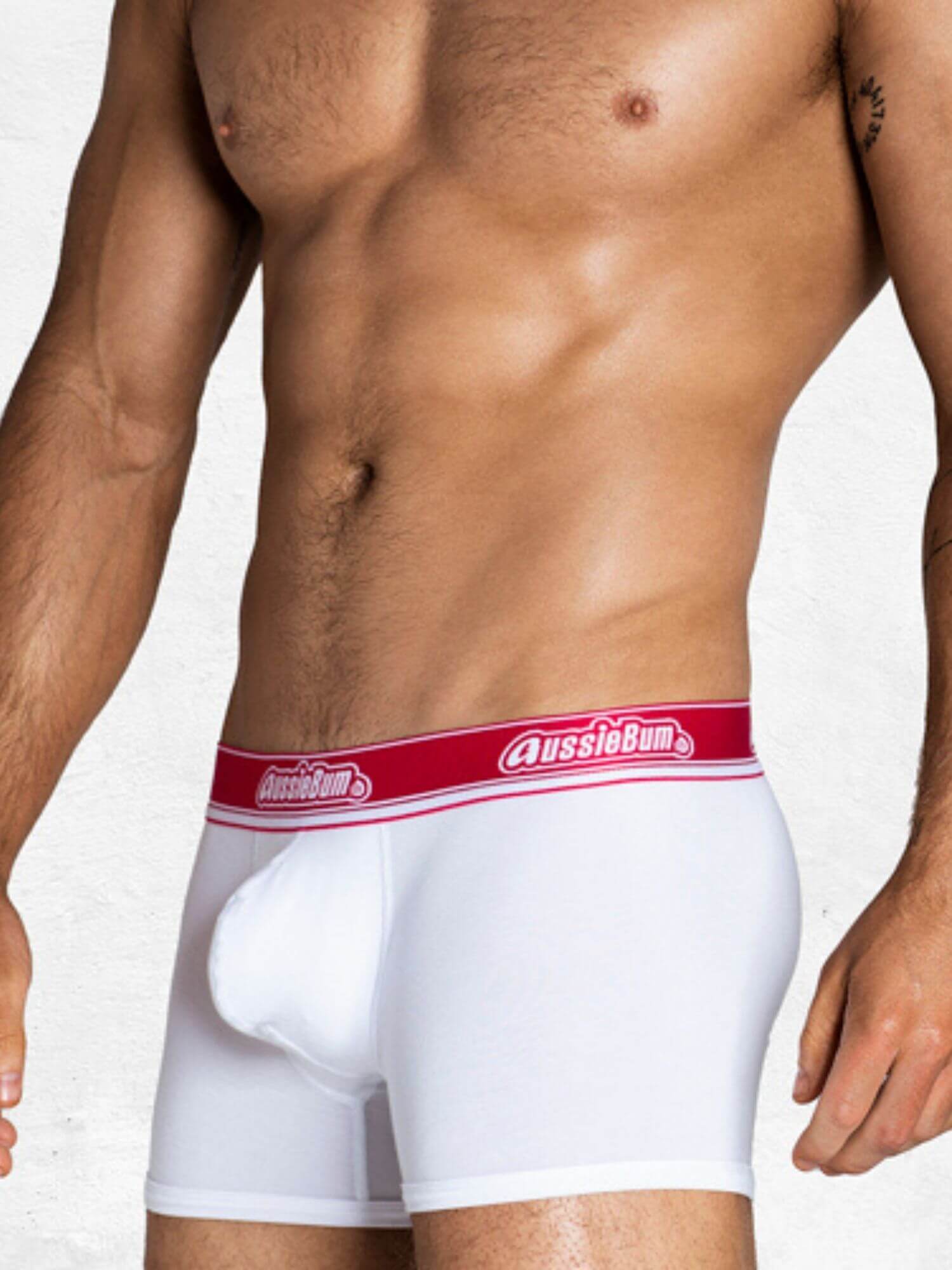 White boxer briefs with red waistband featuring 'AussieBum' brand on a white background