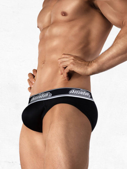 Man wearing black underwear with 'AussieBum' brand logo on a white background