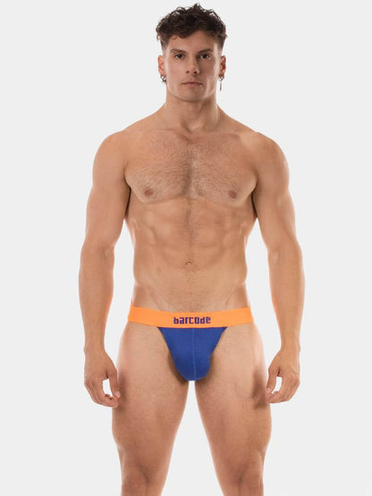 Man wearing a blue and orange swim brief on a white background